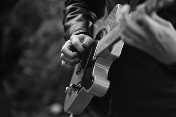 Person playing guitar black and white photo