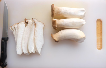 Mushroom origami Anji and the knife on white cutting board.