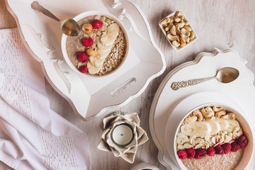 Healthy breakfast with granola, berries, nuts and smoothie. Isolated on white textured wooden background