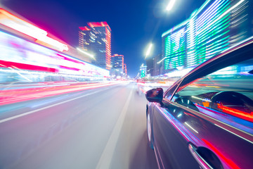 View from Side of Car moving in a night city, Blured road with lights with car on high speed....