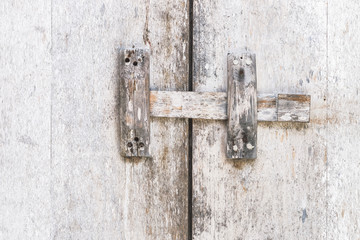 Wooden textured white door with latch, rustic interior in Bali house
