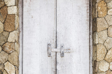 Wooden textured white door with latch, rustic interior in Bali house