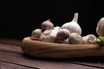 Garlic. Garlic Cloves and Garlic Bulb in vintage wooden bowl.