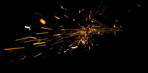 Sparks from metal on construction site as background