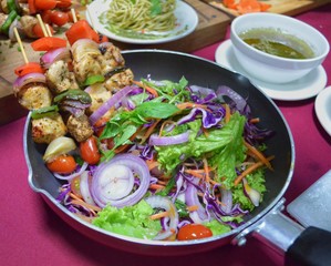 Salad with grilled chicken skewer