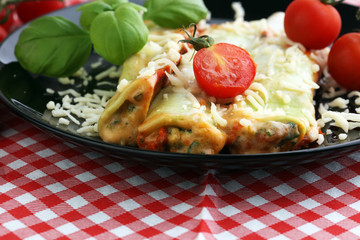 Baked cannelloni with minced meat and bechamel sauce on a plate. Italian cuisine