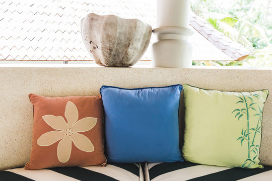 Set of multicolor pillows with flower ornament