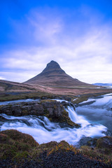 Fototapeta na wymiar Kirkjufell is a free standing mountain of the Snaefellsnes peninsula, on the northern coast of Iceland. Together seen with the mountain, is a waterfall called Kirkjufellsfoss that flows into the sea.
