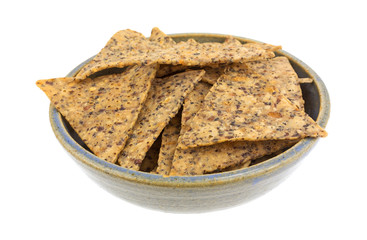 Beans and rice chips in an old stoneware bowl isolated on a white background.