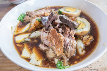 Chinese roll noodle soup or Kuey Jap (paste of rice flour) on wooden table