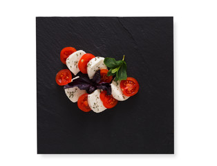 Homemade mozzarella on black stone background