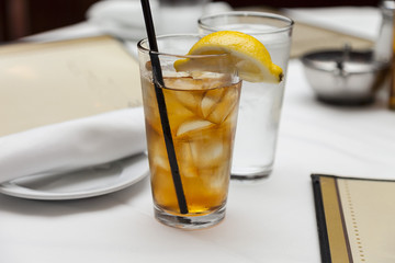 glass of iced tea garnished with a wedge of lemon