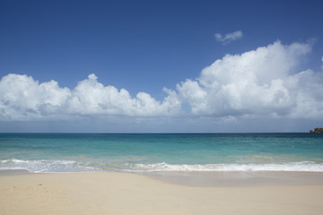 Beach scene Antigua, showing sand, sea and blue sky