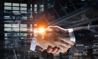 Fototapeta na wymiar Partners shaking hands as symbol of deal
