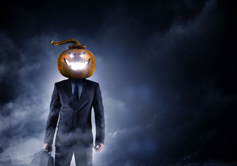 Scary businessman with pumpkin head