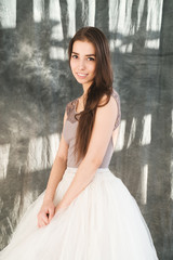 Fototapeta premium woman with blowed dress by wind. sunny dance studio