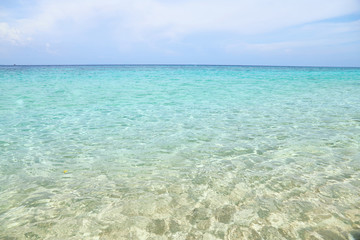 Golden sand beach with blue ocean and cloudscape beautiful sea summer or spring.