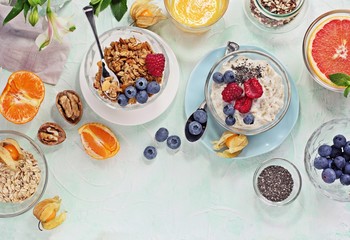 
    Breakfast table with granola, fresh smoothie, juice and various of sandwiches. Healthy eating concept 