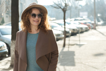 Joyful middle-aged woman enjoying walk outdoors