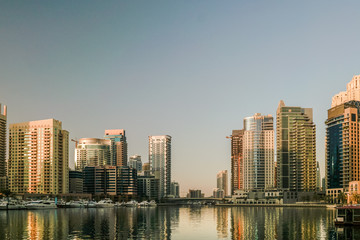 Dubai. In the summer of 2016. Construction of modern skyscrapers in Dubai Marina on the shore of the Arabian Gulf.
