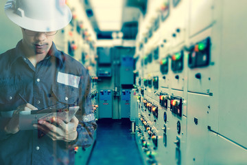 Double exposure of  Engineer or Technician man  working with tablet in switch gear electrical room of oil and gas platform or plant industrial for monitor process, business and industry concept