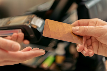 Woman paying for purchase by terminal