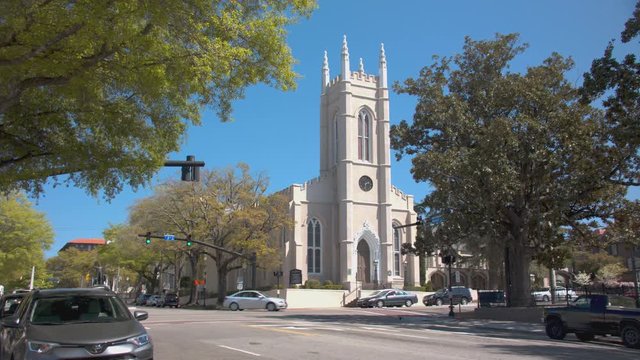 Wilmington NC St. James Parish Building Exterior on a Tree Lined Market Street with Passing Traffic during a Sunny Day in North Carolina