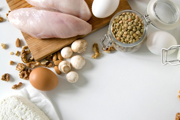 Healthy food full of proteins on white table. Chicken fillet eggs mushrooms, Lentils and peas and cottage cheese. Copy space for text. Sport diet background. Healthcare lifestyle or proteins concept.