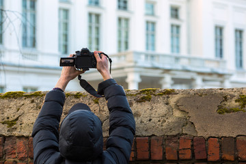 man shooting above the fence