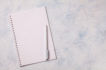 White notepad on a gray background, copyspace, horizontal