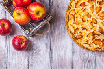 Apple pie, red apples on a gray background, horizontally