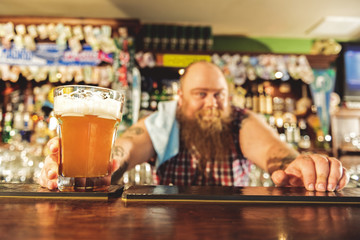 Man arm putting alcohol beverage in alehouse