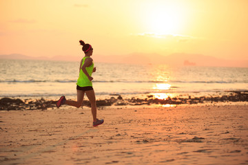 Fototapeta na wymiar Healthy lifestyle young fitness woman running at morning beach