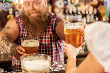 Bearded man giving drinks to waitress