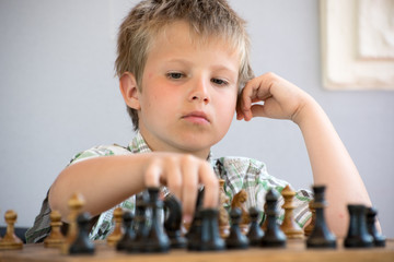 Portrait of a boy playing chess