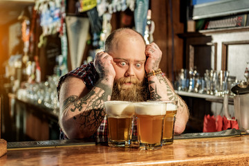 Wonder bearded male watching at beer