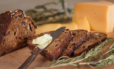 dark bread with nuts and raisins, butter and cheese
