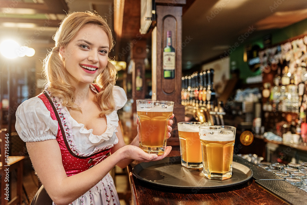 Wall mural Happy female carryng beverage in boozer