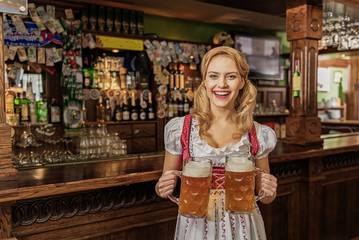 Outgoing woman carrying cups of beer