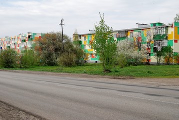 Bright houses along the road - obrazy, fototapety, plakaty