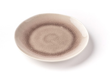 Grey and white round broken textured plate from top on a white background