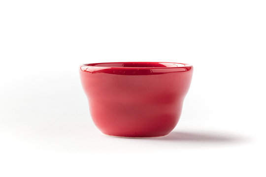 Side view of a red high-gloss finish ceramic bowl on a white background 