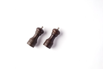 Peppermill and salt grinder laying flat on white background 