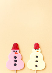 Lollipops new year sweets. Candy christmas snowman, top view flat lay on yellow background. Sweet sucker, lollipop snowman, candy, isolated minimal concept above decoration, new year food background - 147163012