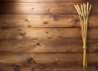 ears of wheat on wooden background
