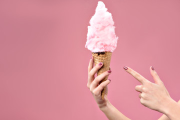 Woman pointing with index finger on candy floss