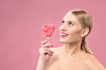 Happy cute girl posing with color candy