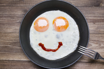 Ovarian fried eggs and ketchup in a frying pan
