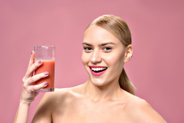 Happy attractive young woman drinking juice