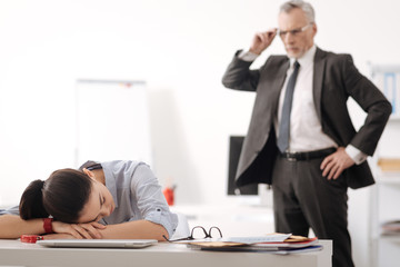 Tired office worker lying her head on hands